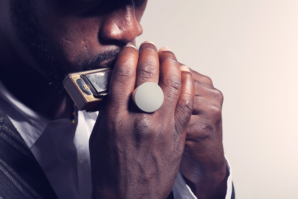 A skilled musician bending a note while playing the harmonica.